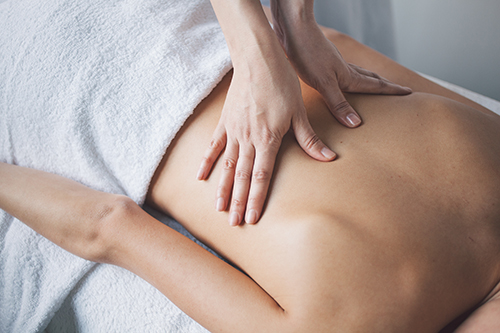 Young woman relaxing with hand massage at beauty spa.